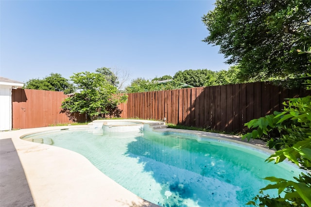 view of pool with an in ground hot tub