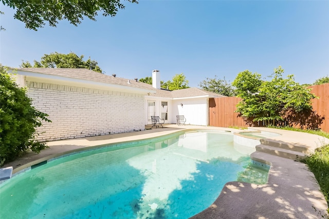 view of pool featuring an in ground hot tub and a patio