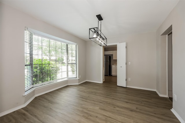 unfurnished dining area featuring dark hardwood / wood-style flooring