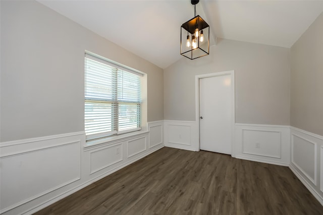 unfurnished room with dark wood-type flooring and vaulted ceiling