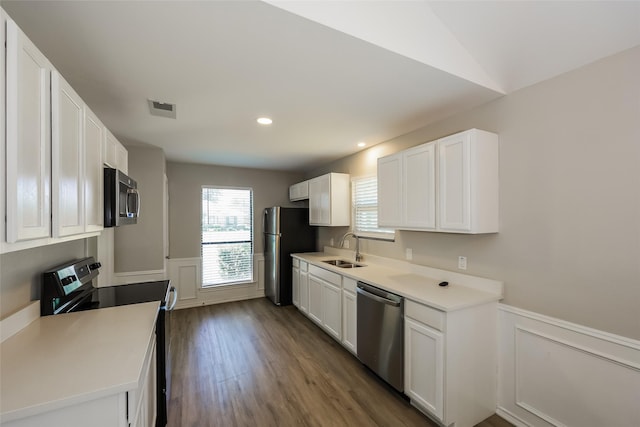 kitchen with appliances with stainless steel finishes, sink, and white cabinets