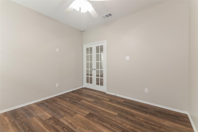 empty room with dark hardwood / wood-style flooring, french doors, and ceiling fan