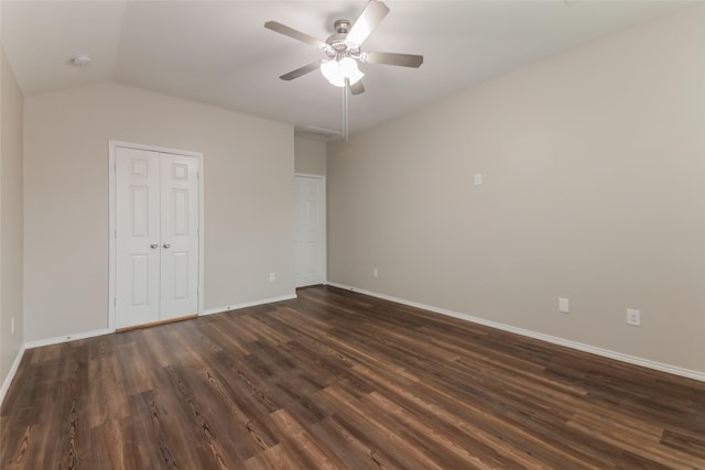 unfurnished bedroom with vaulted ceiling, dark wood-type flooring, ceiling fan, and a closet