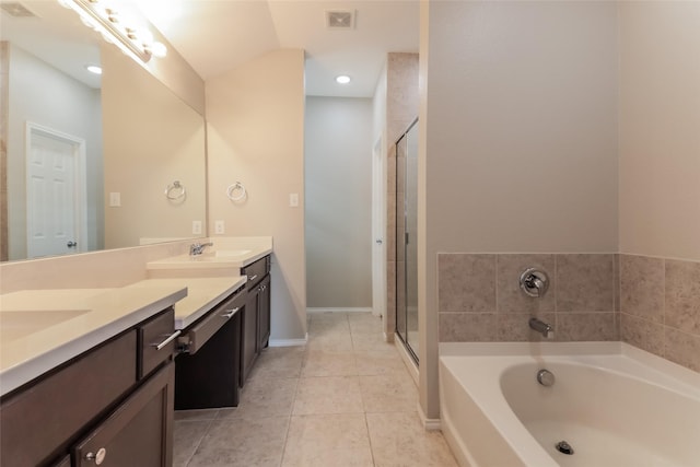 bathroom featuring independent shower and bath, vanity, and tile patterned floors