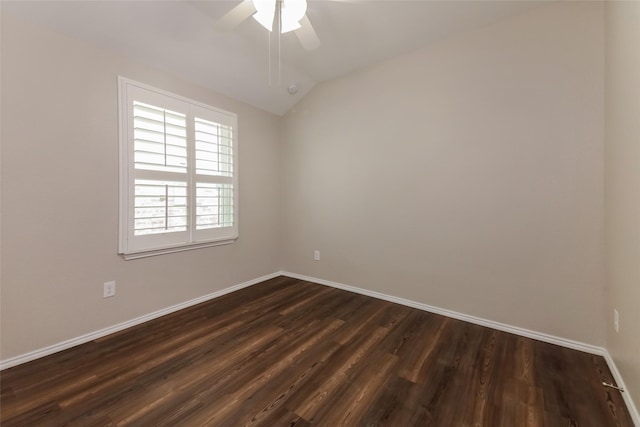 empty room with ceiling fan, dark hardwood / wood-style floors, and vaulted ceiling