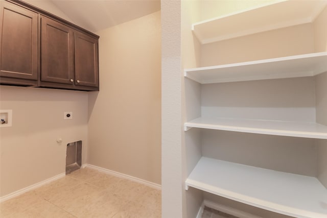 washroom with cabinets, light tile patterned floors, electric dryer hookup, washer hookup, and hookup for a gas dryer