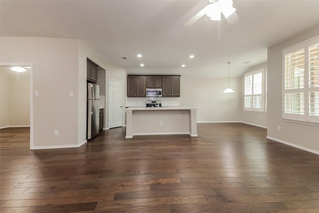 unfurnished living room with ceiling fan and dark hardwood / wood-style flooring