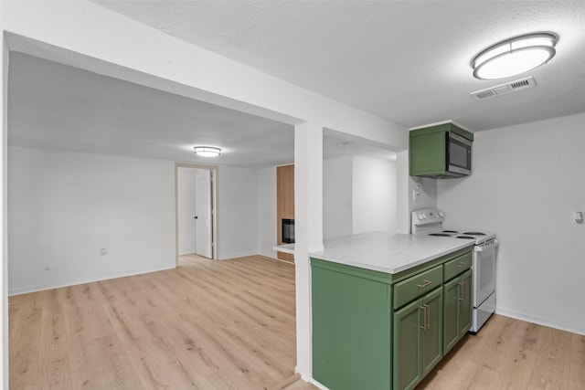 kitchen with white electric stove, green cabinets, a textured ceiling, and light wood-type flooring