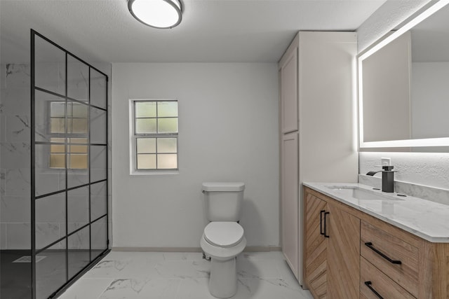 bathroom featuring vanity, tiled shower, a textured ceiling, and toilet