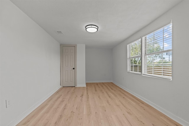 spare room with light hardwood / wood-style floors