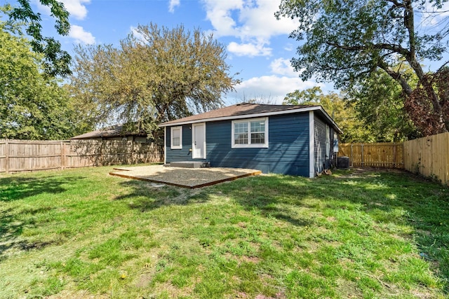 back of house featuring a yard and a patio area