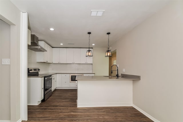 kitchen featuring wall chimney exhaust hood, white cabinetry, stainless steel electric range oven, kitchen peninsula, and pendant lighting