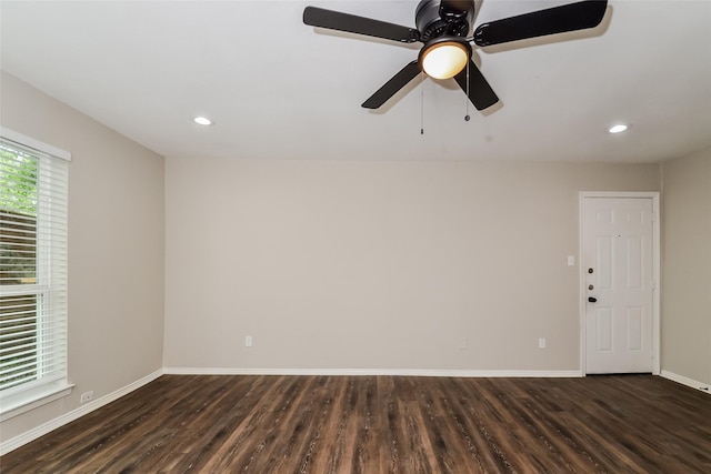 spare room featuring dark wood-type flooring and ceiling fan