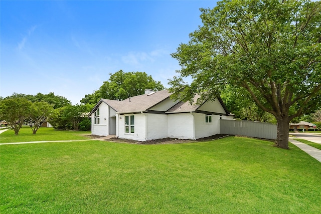 view of property exterior featuring a lawn