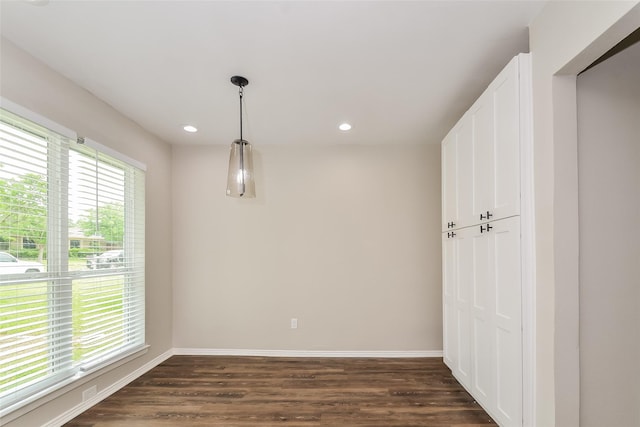 unfurnished dining area with dark hardwood / wood-style floors