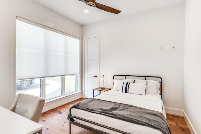 bedroom featuring ceiling fan and light hardwood / wood-style flooring