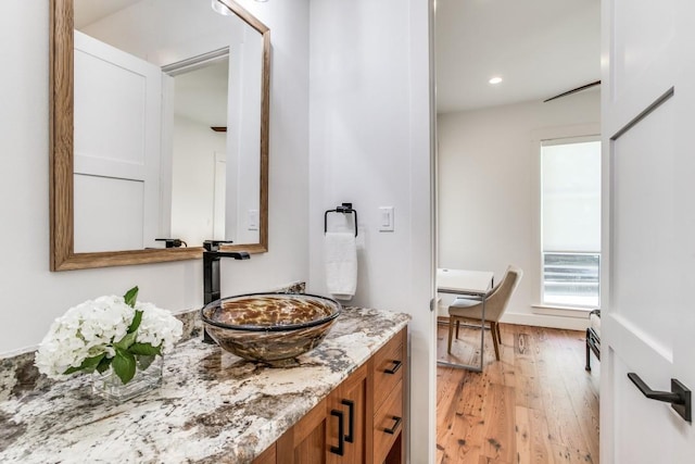 bathroom with vanity and wood-type flooring