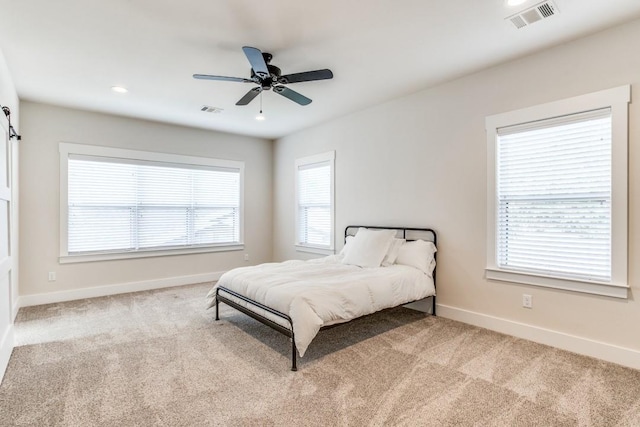 bedroom with light carpet and ceiling fan