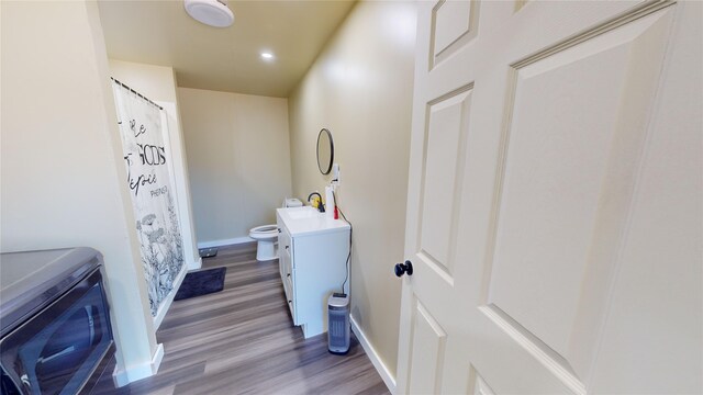 bathroom with vanity, hardwood / wood-style floors, toilet, and a shower with shower curtain