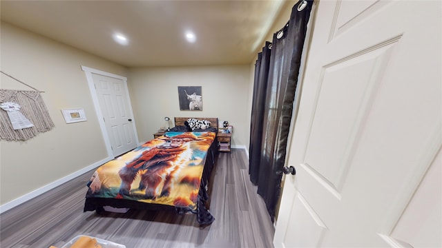 bedroom with dark wood-type flooring