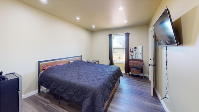 bedroom with dark hardwood / wood-style floors