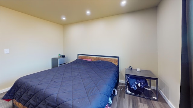 bedroom with wood-type flooring