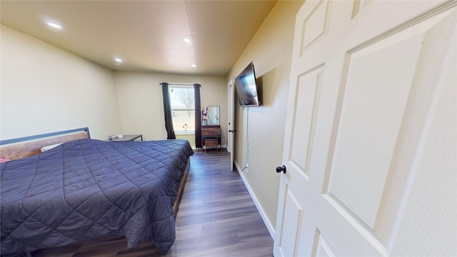 bedroom with dark wood-type flooring