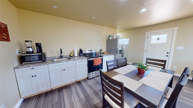 dining room with dark wood-type flooring and sink