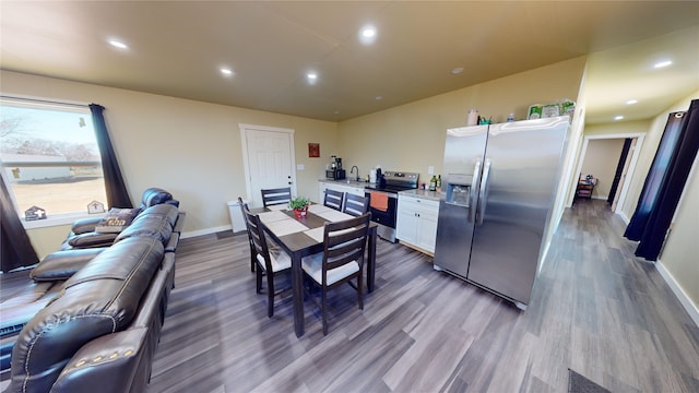 dining space with sink and hardwood / wood-style flooring