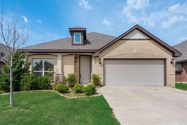 view of front of property featuring a garage and a front lawn