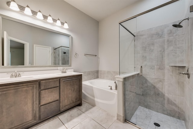 bathroom with vanity, tile patterned floors, and plus walk in shower