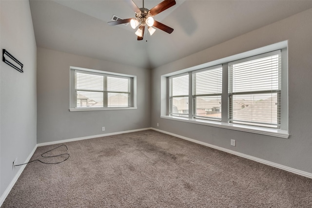 carpeted spare room with vaulted ceiling and ceiling fan