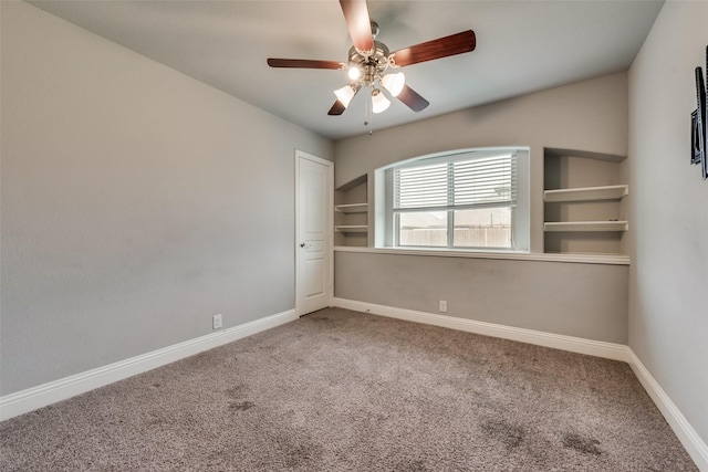 empty room with ceiling fan and carpet floors