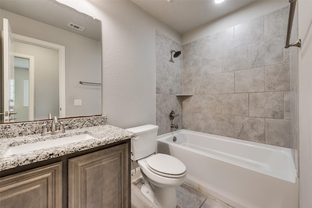 full bathroom featuring vanity, toilet, and tiled shower / bath