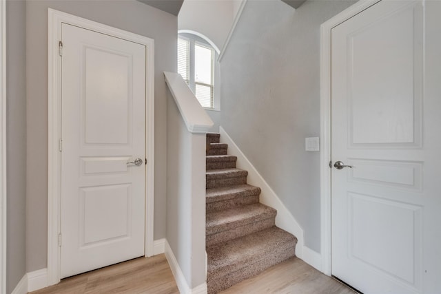 stairs featuring hardwood / wood-style floors