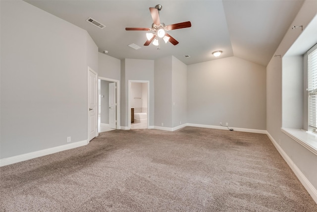 unfurnished bedroom with ceiling fan, lofted ceiling, carpet flooring, and ensuite bath