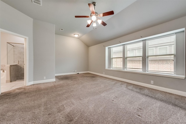 spare room with lofted ceiling, light colored carpet, and ceiling fan