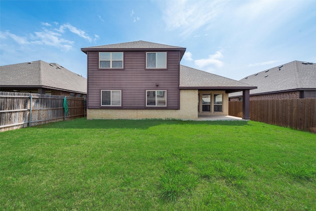 rear view of house with a yard and a patio