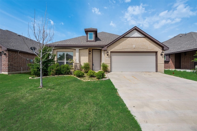 view of front of property featuring a garage and a front yard