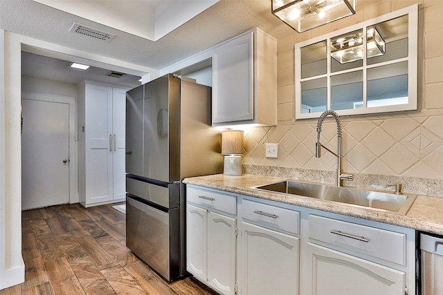 kitchen featuring white cabinetry, sink, backsplash, and dark hardwood / wood-style flooring