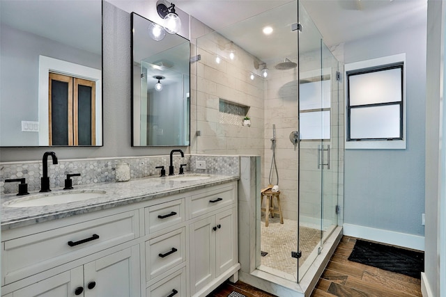 bathroom featuring vanity, hardwood / wood-style flooring, and a shower with door