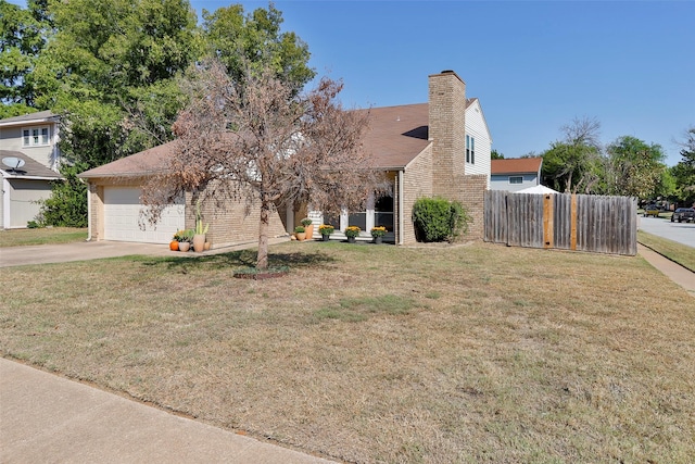 view of front of property featuring a garage and a front yard