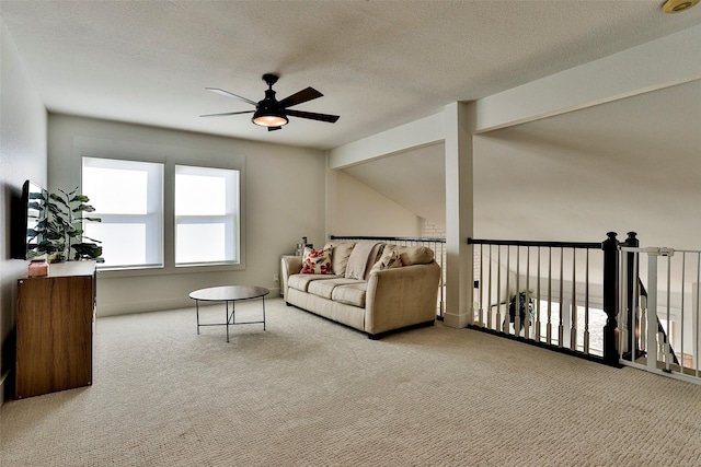 living room featuring a textured ceiling, light colored carpet, and ceiling fan