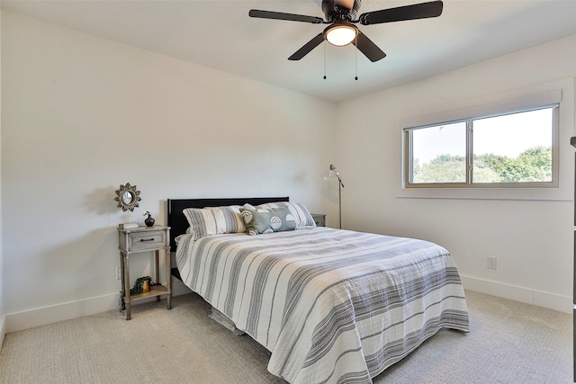 bedroom with light carpet and ceiling fan