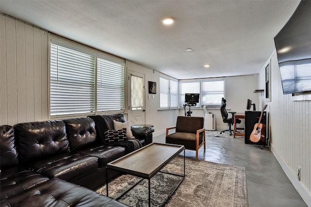 living room featuring concrete flooring and a textured ceiling