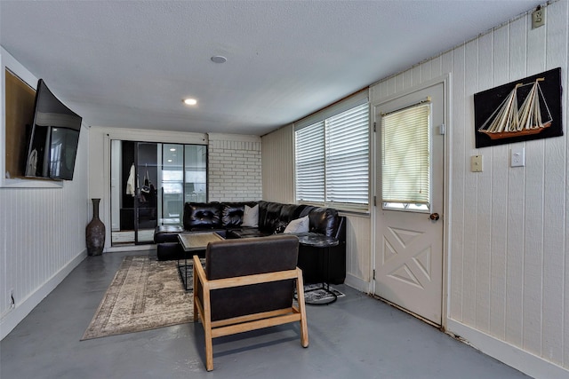 living room featuring concrete floors and a textured ceiling