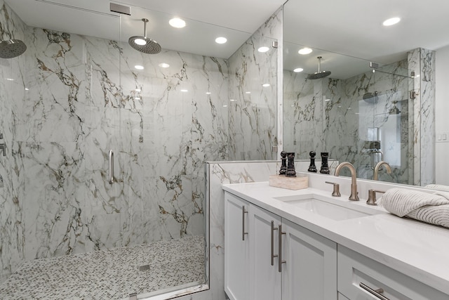 bathroom featuring vanity, a shower with door, and tile walls