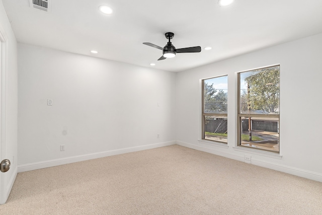 carpeted spare room with ceiling fan