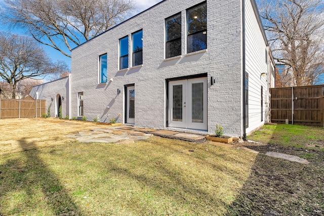 rear view of property featuring french doors, a yard, and a patio