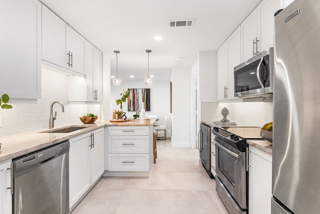 kitchen featuring sink, decorative light fixtures, stainless steel appliances, and white cabinets